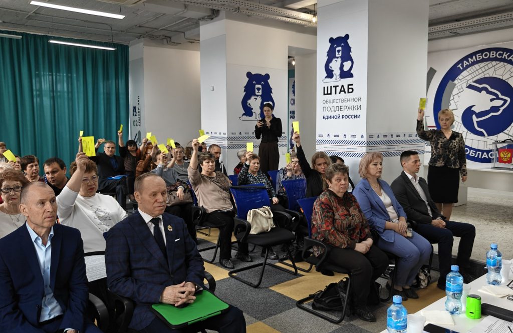 Делегаты голосуют, подняв вверх жёлтые карточки